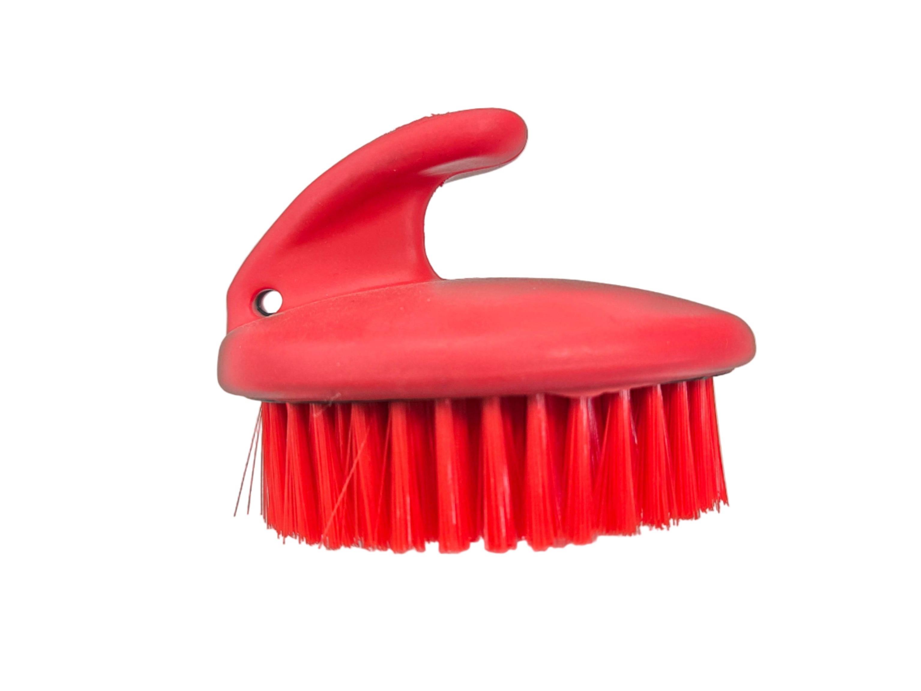 Red brush with a handle on a white surface